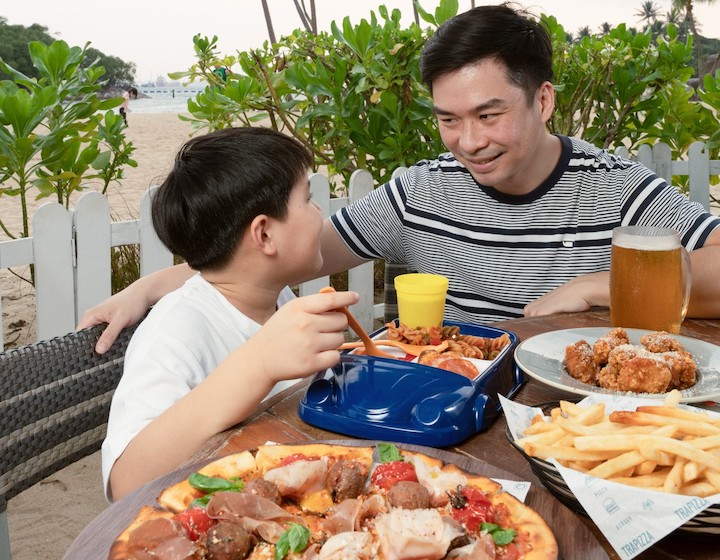 kid friendly restaurants and cafes singapore trapizza father and son with pizza and fries