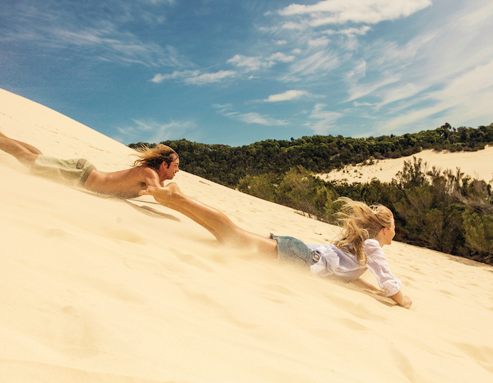 PriceBreaker vacation in Australia Tangalooma Island Resort two people sand tabogganing