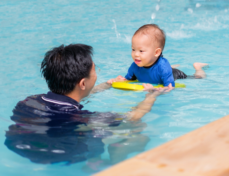 swimming lessons singapore father and son in pool swimming classes near me