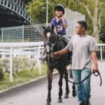 horse riding in singapore - singapore turf club riding centre - boy on a horse
